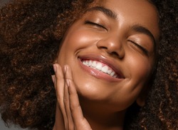 Beautiful african american woman face close up  teeth smile happy positive