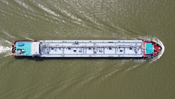 Aerial top down view of tank barge is vessel that is used to carry liquids solids and gas through waterways and rivers and across areas of ocean an essential player in energy and offshore industries