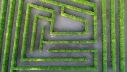 Aerial photo low altitude above bush maze showing different paths just one leading to exit also known as labyrinth is path or collection of paths typically from entrance to goal drone top-down view