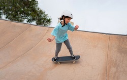 caucasian girl skateboarding in a skate park