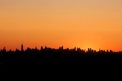 Sunset sillhouette of the new york city skyline. 