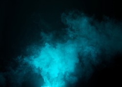 Dark background with cyan, blue fog floating in the air. 