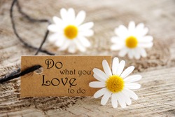 A Natural Looking Label with the Life Quote Do What You Love To Do and white Flowers