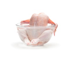Raw chicken in the water isolated on white background. Ready for cooking. 