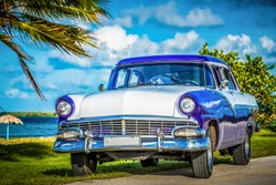 Havana, Cuba - June 30, 2017: American blue white Ford Fairlane classic car parked on the Malecon near the beach in Havana Cuba - Serie Cuba Reportage