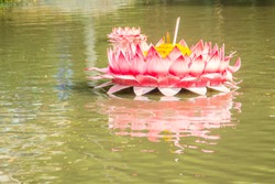 Beautiful pink kratong is floating on the water. Conccept for loy kratongs festival celebrated in Thailand.