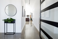 Contemporary home entry hall with polished concrete floors