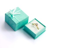 Diamond ring in green gift box isolated on white with copyspace