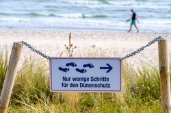 beach erosion control sign in Germany - translation: no trespassing because of beach erosion