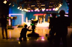 blurred silhouette cameraman with  staff in TV studio station