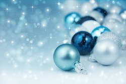 Colorful blue christmas decoration baubles on white.
