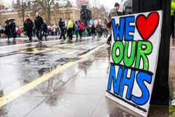 London, England. 3rd February 2018. EDITORIAL. WE LOVE OUR NHS poster sits in the rain at the NHS In Crisis demonstration through central London, in protest of underfunding & privatisation of the NHS.
