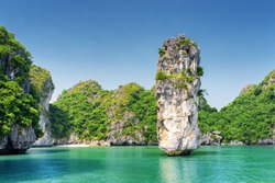 Amazing rock pillar and azure water in the Ha Long Bay (Descending Dragon Bay) at the Gulf of Tonkin of the South China Sea, Vietnam. The Halong Bay is a popular tourist destination of Asia.