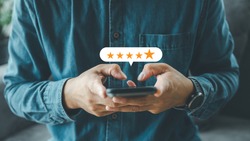 close up Man hand using smartphone with popup five star icon for feedback review satisfaction service, Customer service experience and business satisfaction survey.