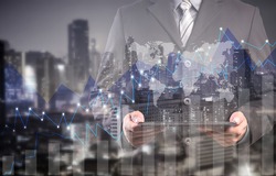 Double exposure of success businessman using digital tablet with city landscape background.Forex graph on the business city centre. A metaphor of international financial consulting.investment concept