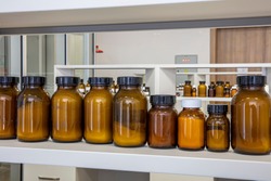 Close up amber color bottles in laboratory. Amber bottle for storing scientific samples.