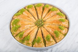 Carrot Slice Baklava (Turkish: Havuc Dilim Baklava) on tray. Traditional Baklava from Gaziantep, Turkey. Baklava with pistachio on marble background.