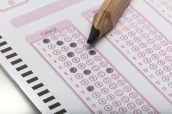 Answer sheet for testing. Standard school exam answer sheet and pencil. Answer sheet focus on pencil.
