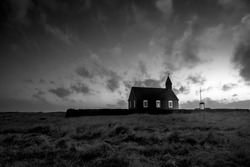 An old church in a remote countryside in Iceland during a rainy, stormy evening
