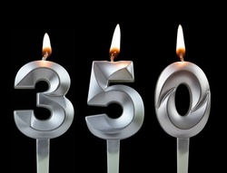 Silver birthday candles isolated on black background, number 350