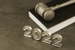 Judge gavel, legal book and numbers 2022. New laws and rules concept.
