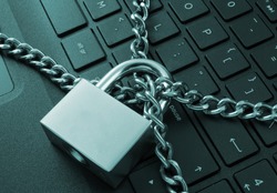 Cyber safety concept, locked chain on laptop computer keyboard 