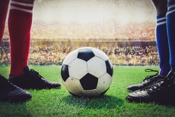 feet of soccer players kick off in the stadium match