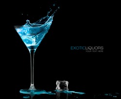 Stemmed cocktail glass with blue alcoholic drink splashing out, close-up isolated on black. Template design with sample text