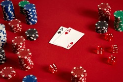Poker cards and gambling chips on red background