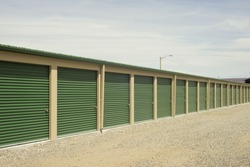 Green and beige outdoor self storage units.