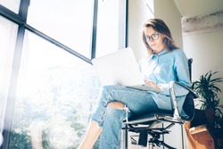 Hipster Woman use Laptop huge Loft Studio.Student Researching Process Work.Young Business Team Working Creative Startup modern Office.Analyze market stock,new strategy.Blurred,film effect.Horizontal