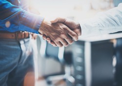 Close up view of business partnership handshake concept.Photo of two businessman handshaking process.Successful deal after great meeting.Horizontal,flare effect, blurred background
