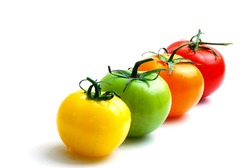close up of alignment of multicolored tomatoes