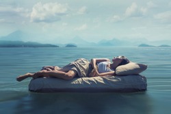 Sleeping woman lies on airbed in water.
