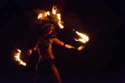 Fire show artist on the beach fire in the dark