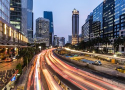 Rush hour traffic in Jakarta business district along the city main avenue, Jalan Sudirman, at night in Indonesia capital city