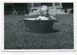 Vintage photo (1955) of baby taking a bath in a washtub