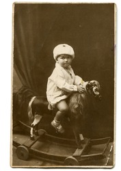 Vintage photo of little girl on rocking horse (circa 1928)