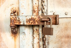 old key lock on rusty  freight container locked