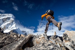 Hiker jumps on the rock near Everest in Nepal