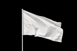 White flag waving in the wind, isolated on black background