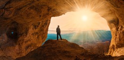 Beautiful amazing sunset. Mountains in north country Russia Caucasus. Unique landscape mainsail. Silhouette of a man. Old cave. Active sport and hobby. Spelunking background. Quest