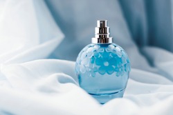 blue perfume on light background
