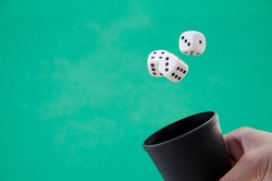 Dice in the air on green background