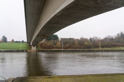 On a cloudy cold day in Hainaut, this Bridge lies over a waterway