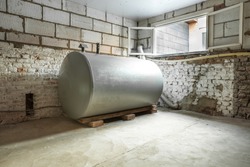 in a separate room in a old building, there is a heating oil tank