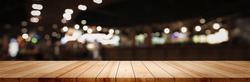 Panoramic clean wood counter table top on blur street night cafe background pub coffee desk shop montage dark scene, Blurry wide wooden texture shelf bar in luxury restaurant food kitchen backdrop