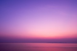 Twilight sunrise sky over tropical sea and beach in Thailand. Purple filtered