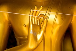 Golden hand of image Buddha close up.