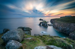 A long exposure of a sunset over Lands End in Cornwall, looking out towards the Long Ships lighthouse